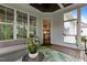 Beautiful sunroom with wicker furniture, a ceiling fan, and an open doorway to the bright kitchen at 2077 Amalfi Pl, Apex, NC 27502