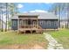 Backyard features a covered porch, stone pathway, and sprawling yard at 210 Sorrel Dr, Franklinton, NC 27525