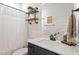 Stylish bathroom with industrial shelves, dark vanity, and decorative mirror at 210 Sorrel Dr, Franklinton, NC 27525