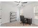 Neutral bedroom with desk, chair, ceiling fan, and natural light streaming in from the large windows at 210 Sorrel Dr, Franklinton, NC 27525