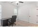 Neutral bedroom with desk, chair, ceiling fan, and natural light streaming in from the large windows at 210 Sorrel Dr, Franklinton, NC 27525
