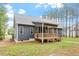 This single Gathering home features a rear wooden deck, dark siding and sits on a lush lot of land at 210 Sorrel Dr, Franklinton, NC 27525