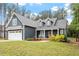 Charming home featuring a two-car garage, well-maintained lawn, and covered front porch at 210 Sorrel Dr, Franklinton, NC 27525