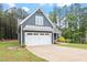 Two-car garage with an expansive driveway and manicured landscaping at 210 Sorrel Dr, Franklinton, NC 27525