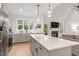 Modern kitchen with large island, pendant lighting, and stainless steel appliances at 210 Sorrel Dr, Franklinton, NC 27525