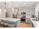 Bright kitchen features an island with seating, stainless appliances and ample cabinets at 210 Sorrel Dr, Franklinton, NC 27525