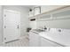 Functional laundry room with modern washer/dryer units and ample storage at 210 Sorrel Dr, Franklinton, NC 27525