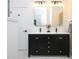 Bathroom with black vanity, double sinks, gold framed mirrors, and black hardware at 2106 University Dr, Durham, NC 27707