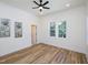 This light-filled bedroom features wood flooring, white trim, and a ceiling fan at 2106 University Dr, Durham, NC 27707
