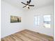 Bedroom with hardwood floors, white walls, and a ceiling fan at 2106 University Dr, Durham, NC 27707