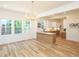 Open dining area featuring ample natural light, modern lighting, and view into the kitchen at 2106 University Dr, Durham, NC 27707