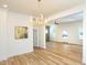 Dining room featuring new flooring, updated light fixture, and neutral walls at 2106 University Dr, Durham, NC 27707