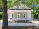 Charming exterior featuring a cozy porch with white columns and craftsman style details at 2106 University Dr, Durham, NC 27707