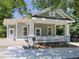 Charming exterior featuring a cozy porch, white railing, and manicured landscaping at 2106 University Dr, Durham, NC 27707