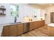 A bright kitchen featuring white subway tiles, stainless steel appliances, granite countertops, and custom wood cabinets at 2106 University Dr, Durham, NC 27707