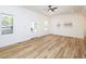 Bright living room with modern ceiling fan, new flooring, and a view to the front porch at 2106 University Dr, Durham, NC 27707