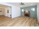 Open-concept living room featuring new flooring, a brick fireplace, and neutral paint at 2106 University Dr, Durham, NC 27707