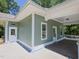 Exterior showcasing a wooden deck and a light green siding with white doors and trim at 2106 University Dr, Durham, NC 27707