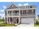 Elegant two-story home with a covered porch, two-car garage, and neutral color palette at 2178 Pink Peony Circle Lot 167 Cir, Durham, NC 27703