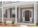 Inviting front entrance with a dark wood door, white trim, and partial brick facade at 2178 Pink Peony Circle Lot 167 Cir, Durham, NC 27703