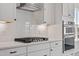 A well-appointed kitchen with white subway tile backsplash, gas range, stainless appliances, and sleek countertops at 2178 Pink Peony Circle Lot 167 Cir, Durham, NC 27703