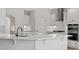 Open-concept kitchen featuring a large island with quartz countertops and modern black faucet and fixtures at 2178 Pink Peony Circle Lot 167 Cir, Durham, NC 27703