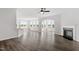 Open-concept living area with hardwood floors, abundant natural light, and fireplace, great for gathering at 2178 Pink Peony Circle Lot 167 Cir, Durham, NC 27703