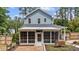 Back of home featuring screened porch and brick patio, ideal for outdoor living at 225 Sacred Fire Rd, Louisburg, NC 27549