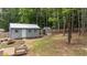 The backyard features a charming shed, lush landscaping, and a neatly maintained lawn, blending functionality with natural beauty at 225 Sacred Fire Rd, Louisburg, NC 27549