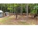 A serene backyard offers a private retreat with mature trees and a wooden fence, creating a peaceful and secluded outdoor space at 225 Sacred Fire Rd, Louisburg, NC 27549