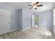 Bedroom features carpet, fresh light blue paint, and a door leading to another room at 225 Sacred Fire Rd, Louisburg, NC 27549