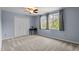 This carpeted bedroom features a ceiling fan, natural light and a closet at 225 Sacred Fire Rd, Louisburg, NC 27549