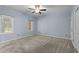 Bedroom with carpet, fresh light blue paint, ceiling fan and natural light at 225 Sacred Fire Rd, Louisburg, NC 27549