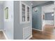 Hallway featuring hardwood floors, a glass cabinet, and fresh light blue paint at 225 Sacred Fire Rd, Louisburg, NC 27549