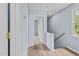 Upstairs hallway featuring hardwood floors and a window overlooking the backyard at 225 Sacred Fire Rd, Louisburg, NC 27549