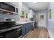 Modern kitchen features stainless steel appliances, light countertops, and blue cabinets, combining style and functionality at 225 Sacred Fire Rd, Louisburg, NC 27549