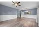 Inviting living room showcasing hardwood floors, wainscoting, modern lighting, and seamless transition between spaces at 225 Sacred Fire Rd, Louisburg, NC 27549