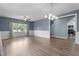Spacious living room boasts hardwood floors, wainscoting, updated lighting, and an open floor plan at 225 Sacred Fire Rd, Louisburg, NC 27549