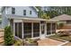 Exterior view of sunroom, featuring a brick patio and ample windows at 225 Sacred Fire Rd, Louisburg, NC 27549