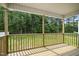 A charming back porch overlooking a lush, green yard with mature trees at 235 Eason Creek Way, Clayton, NC 27527