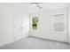 This bedroom features plush carpet, a ceiling fan, a window, and a closet at 235 Eason Creek Way, Clayton, NC 27527