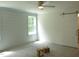 Bright bedroom with modern ceiling fan, gray carpet, and a white sliding barn door at 235 Eason Creek Way, Clayton, NC 27527