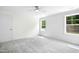 Well-lit bedroom with two windows and neutral carpet at 235 Eason Creek Way, Clayton, NC 27527