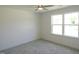 Cozy bedroom with plush carpet and natural light from a large window at 235 Eason Creek Way, Clayton, NC 27527