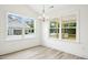 Bright dining area with a modern chandelier and views to a covered porch at 235 Eason Creek Way, Clayton, NC 27527
