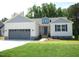 Charming single-story home featuring a two-car garage and well-manicured lawn at 235 Eason Creek Way, Clayton, NC 27527