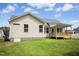 Back exterior of the home with a porch and a grassy lawn at 235 Eason Creek Way, Clayton, NC 27527