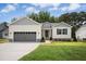 Charming single-story home featuring a grey garage, blue shutters, and a well-manicured lawn at 235 Eason Creek Way, Clayton, NC 27527