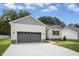 Front exterior of home with large garage and driveway at 235 Eason Creek Way, Clayton, NC 27527