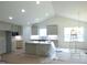 Bright kitchen with white cabinets, granite countertops, and a central island ready for finishing touches at 235 Eason Creek Way, Clayton, NC 27527